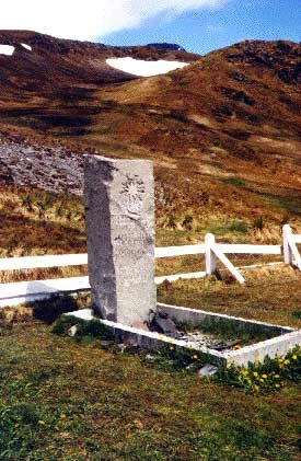 Shackleton's gravestone in South Georgia, a weathered stone monument set in a remote cemetery landscape, symbolizing his enduring legacy as a leader who prioritized human resilience and survival over material success. The grave reflects the stark, isolated environment of the Southern Ocean region where Shackleton's greatest achievements unfolded.